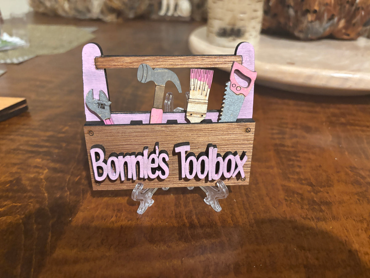 This view is of "Bonnies Toolbox". 
This item is shown here on a easel which is included. it has 2 Strong Magnets and a Hanger on the back. 
 3d Unique design, Handcrafted, this item is not printed. Its laser engraved and precision cut. 
The tools are removable and can be replaced in any slot you wish.

This item measures approximately 3.5" X 4.0 inches.